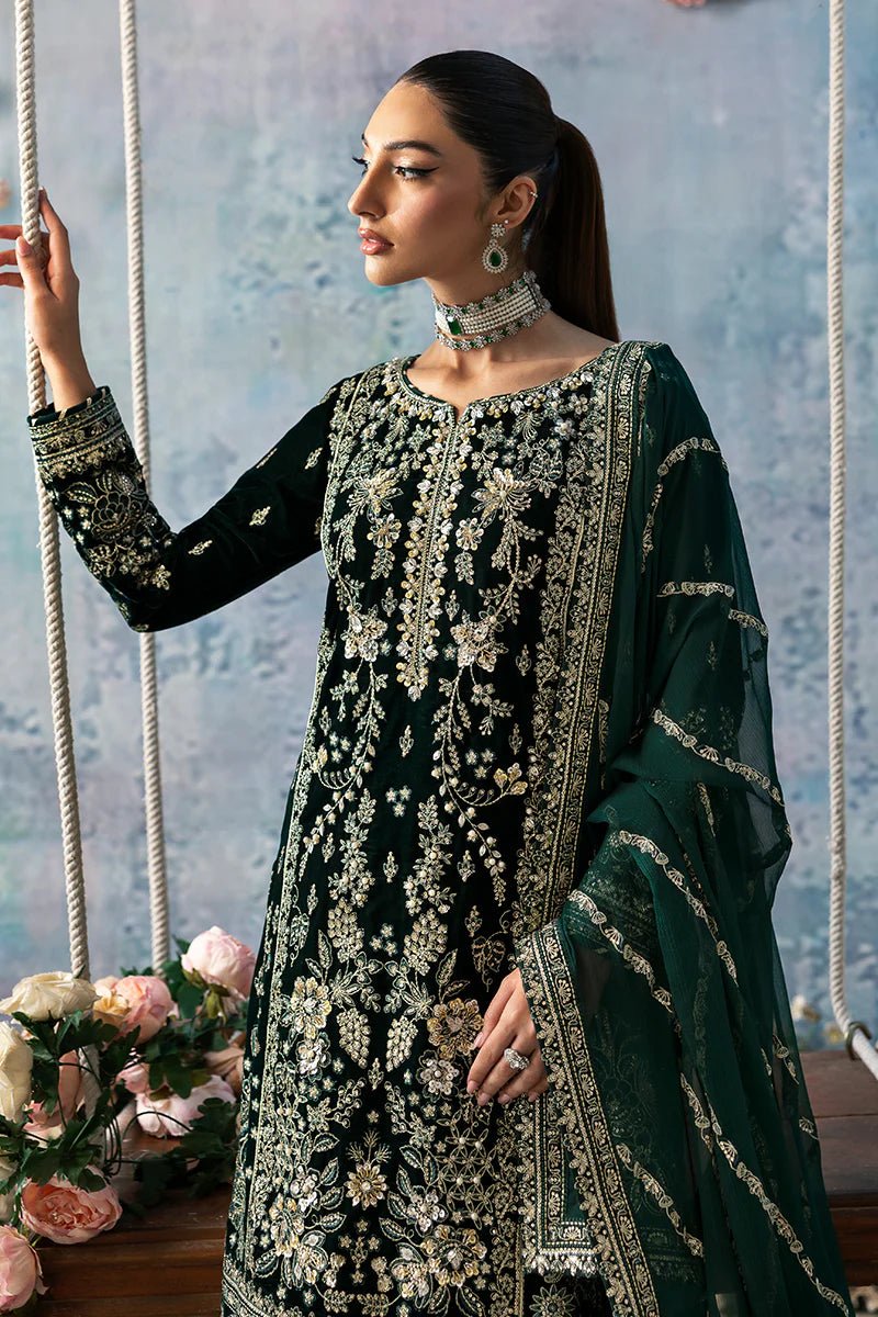 Model wearing Eden from Gulaal's Celeste Unstitched Velvet '24 collection in deep green. Luxury pret, festive, Pakistani clothes online in UK.