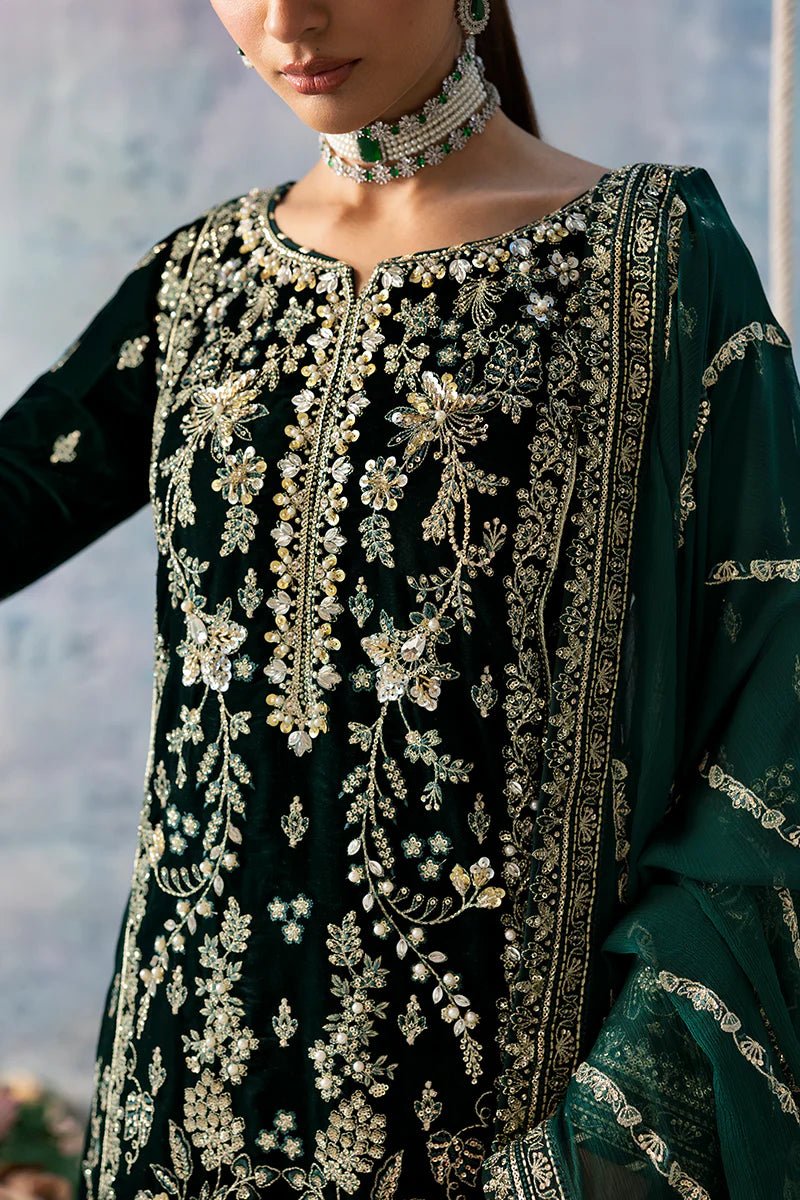 Model wearing Eden from Gulaal's Celeste Unstitched Velvet '24 collection in deep green. Luxury pret, festive, Pakistani clothes online in UK.