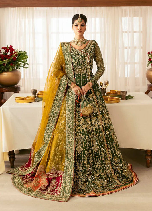 Model wearing Gulaal Maahru deep green and mustard embroidered wedding lehenga with intricate embellishments and contrasting dupatta. Shop Pakistani clothes online in the UK now.