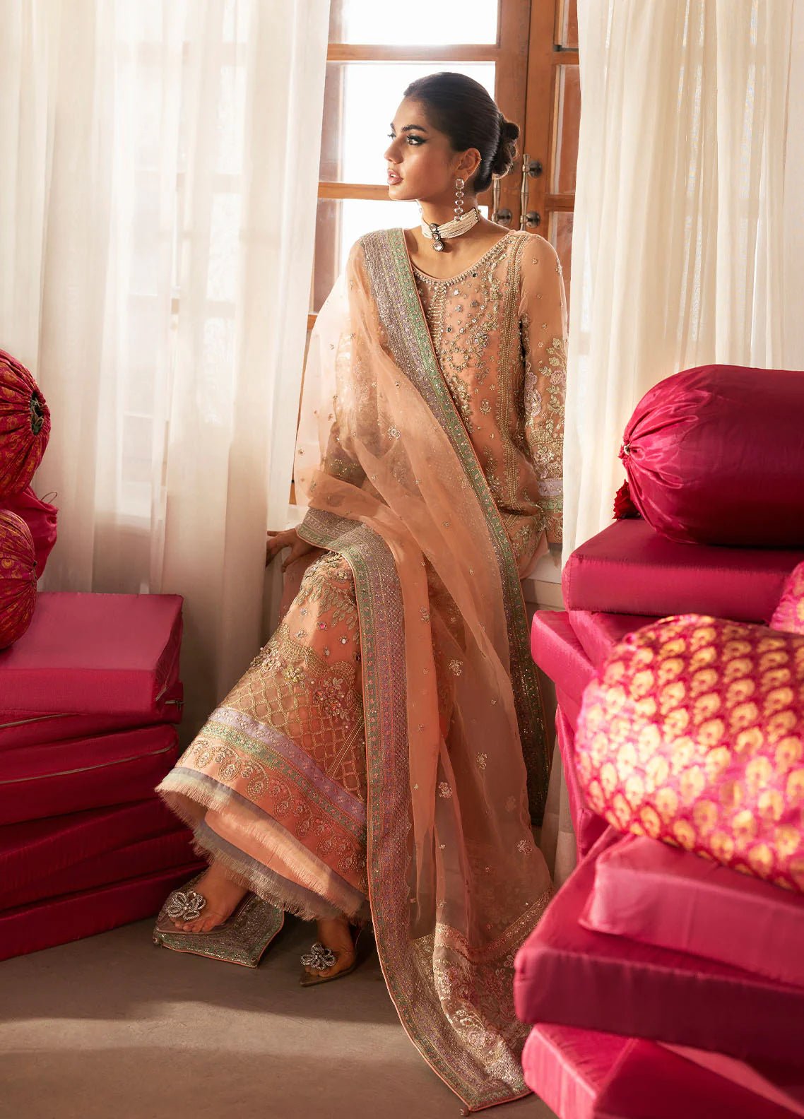 Model wearing Gulaal Raniya peach gold embroidered chiffon dress with intricate detailing and matching dupatta. Shop Pakistani clothes online in the UK now.