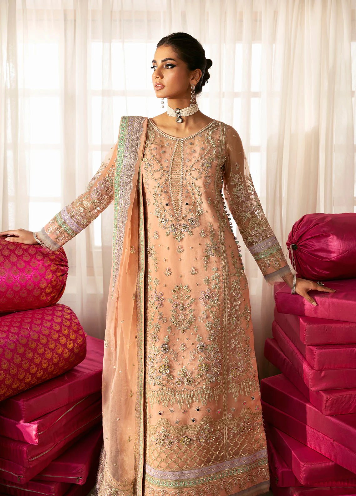 Model wearing Gulaal Raniya peach gold embroidered chiffon dress with intricate detailing and matching dupatta. Shop Pakistani clothes online in the UK now.