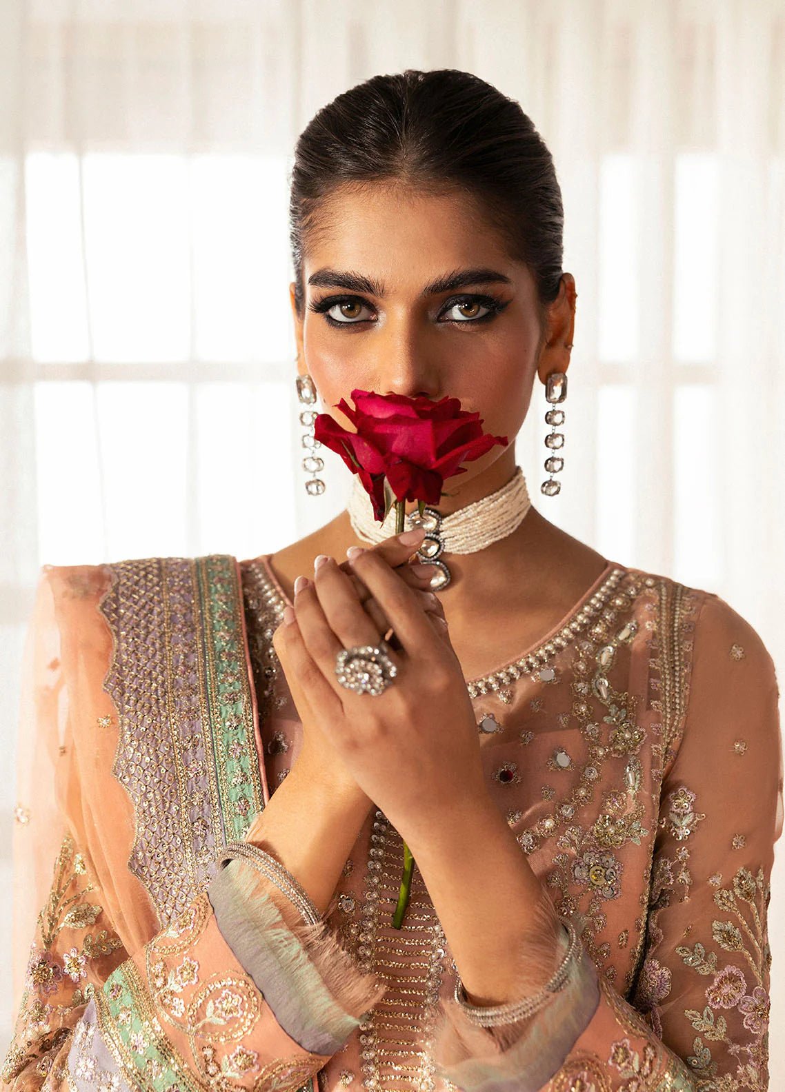 Model wearing Gulaal Raniya peach gold embroidered chiffon dress with intricate detailing and matching dupatta. Shop Pakistani clothes online in the UK now.