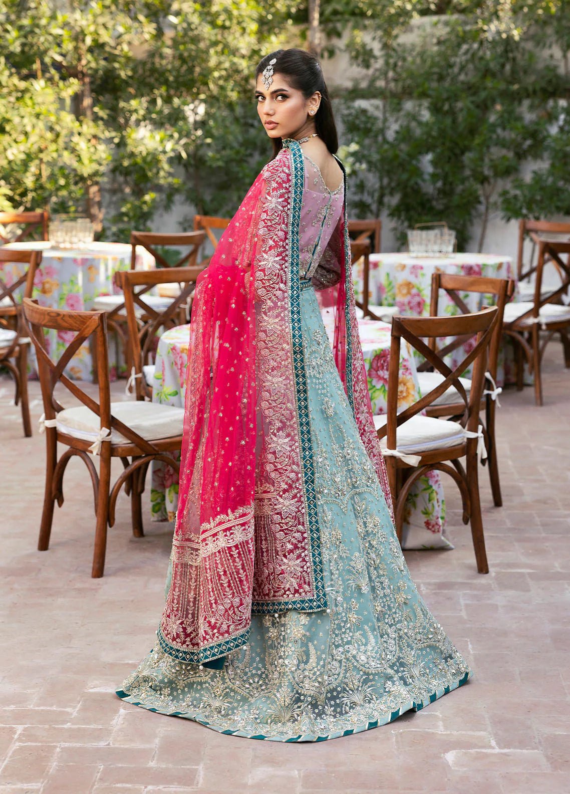 Model wearing Gulaal Shanaya pastel blue and pink embroidered wedding lehenga with intricate embellishments and contrasting dupatta. Shop Pakistani clothes online in the UK now.