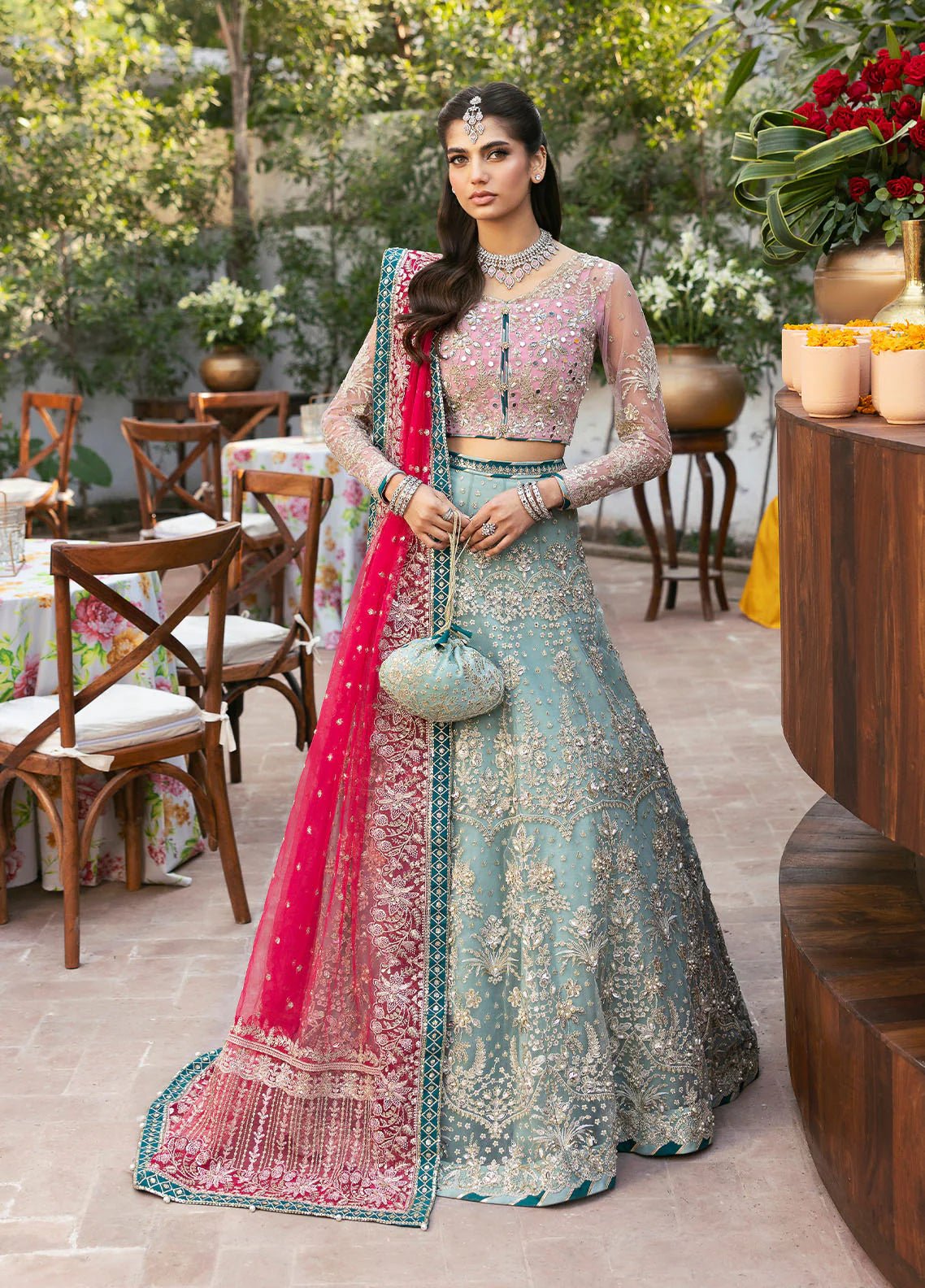 Model wearing Gulaal Shanaya pastel blue and pink embroidered wedding lehenga with intricate embellishments and contrasting dupatta. Shop Pakistani clothes online in the UK now.