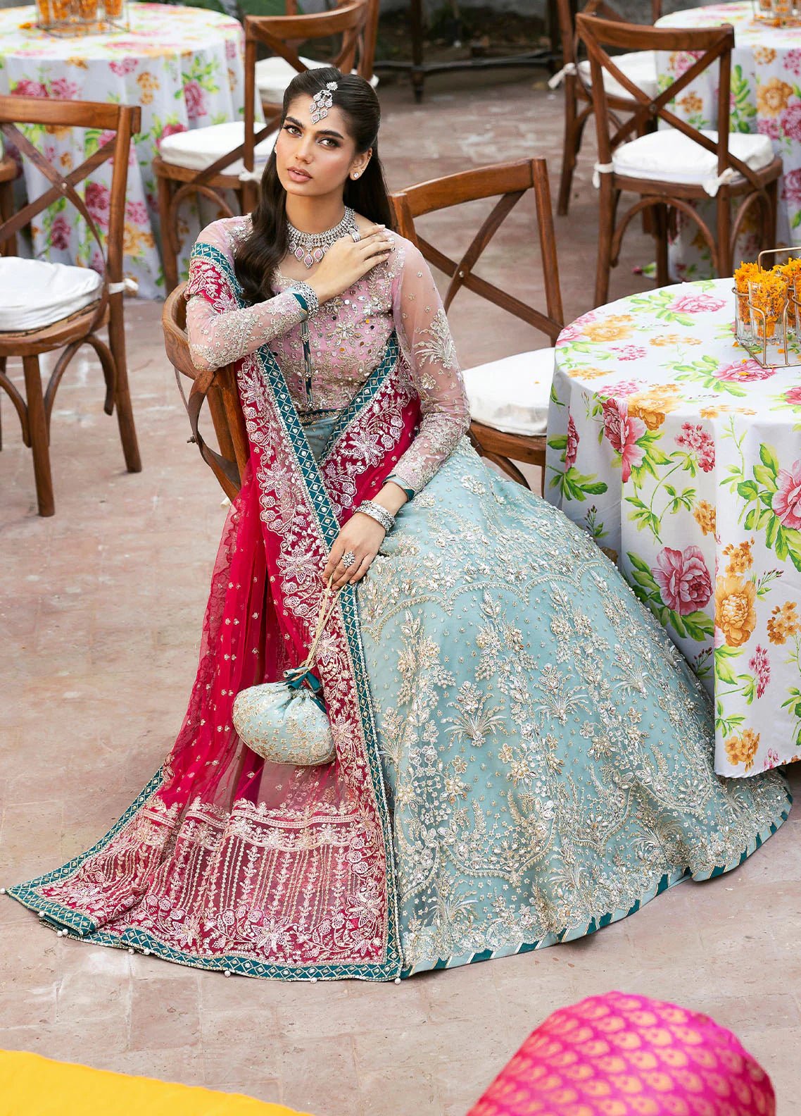 Model wearing Gulaal Shanaya pastel blue and pink embroidered wedding lehenga with intricate embellishments and contrasting dupatta. Shop Pakistani clothes online in the UK now.