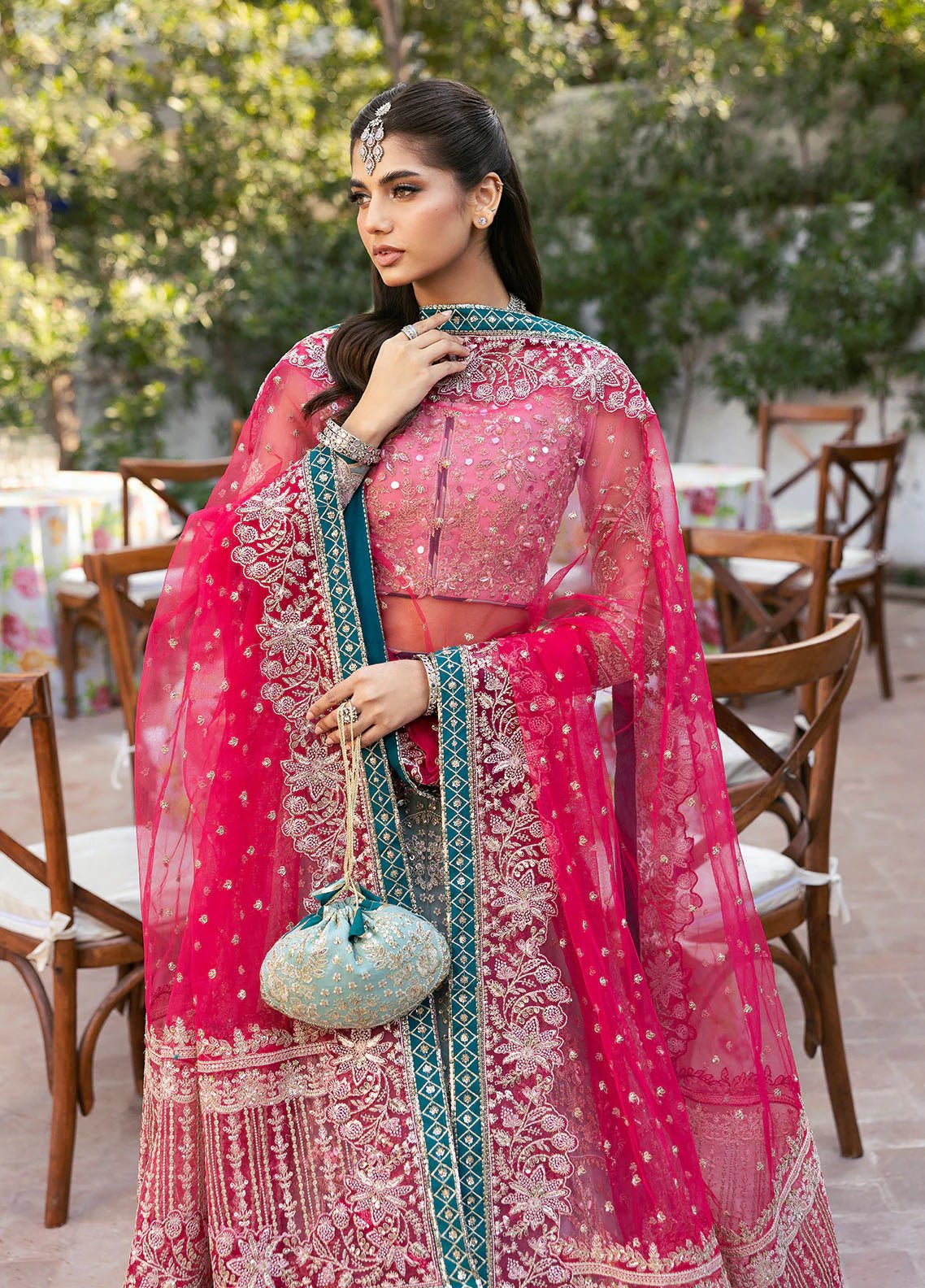 Model wearing Gulaal Shanaya pastel blue and pink embroidered wedding lehenga with intricate embellishments and contrasting dupatta. Shop Pakistani clothes online in the UK now.