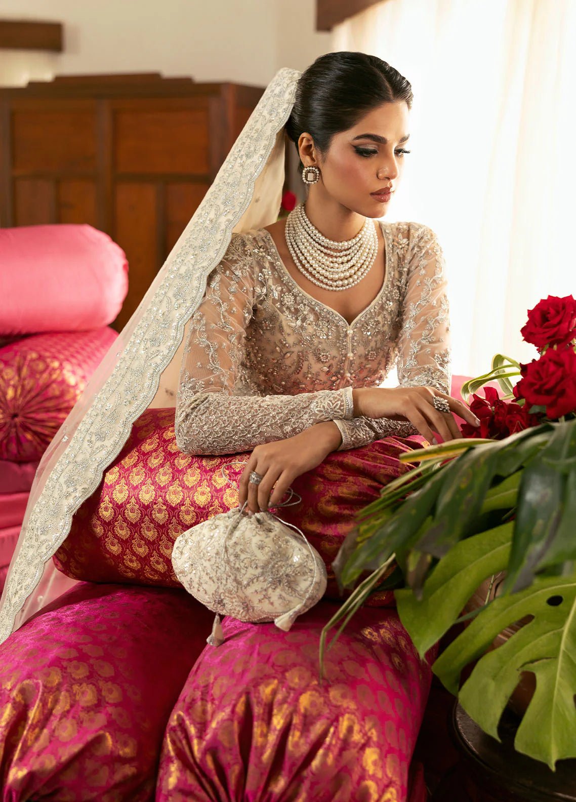 Model wearing Gulaal Sitara ivory silver embroidered chiffon dress with intricate embellishments and matching dupatta. Shop Pakistani clothes online in the UK now.