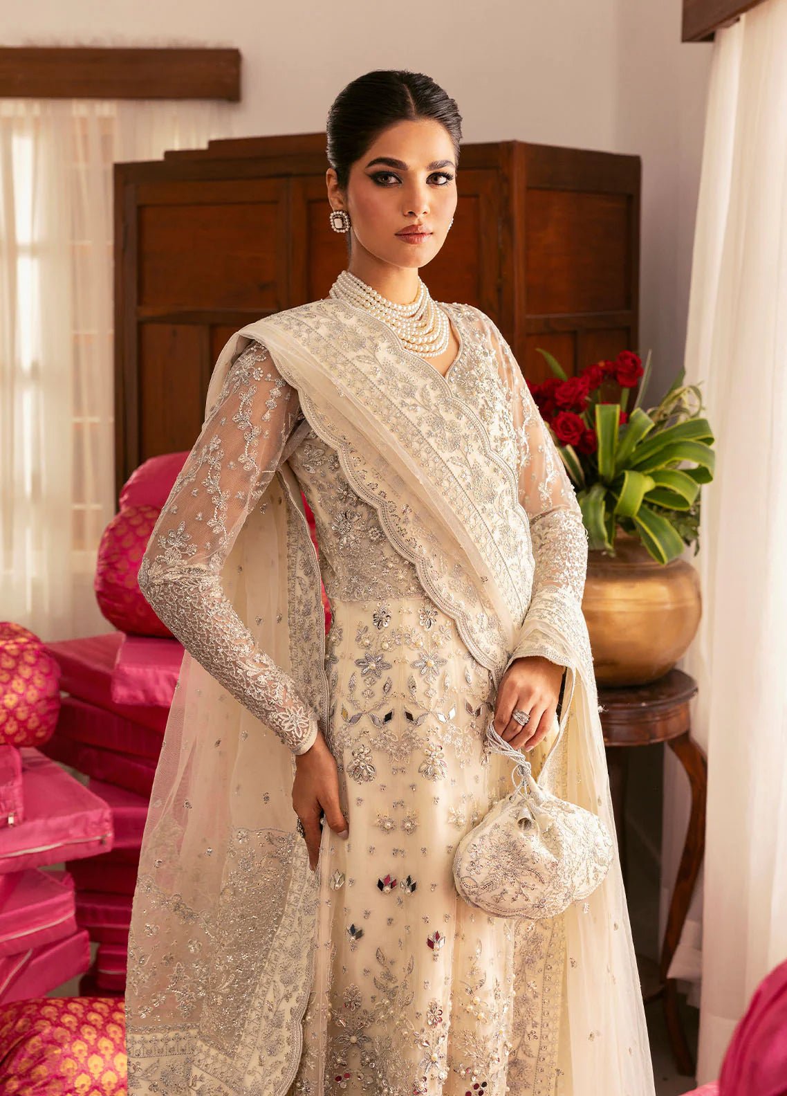 Model wearing Gulaal Sitara ivory silver embroidered chiffon dress with intricate embellishments and matching dupatta. Shop Pakistani clothes online in the UK now.