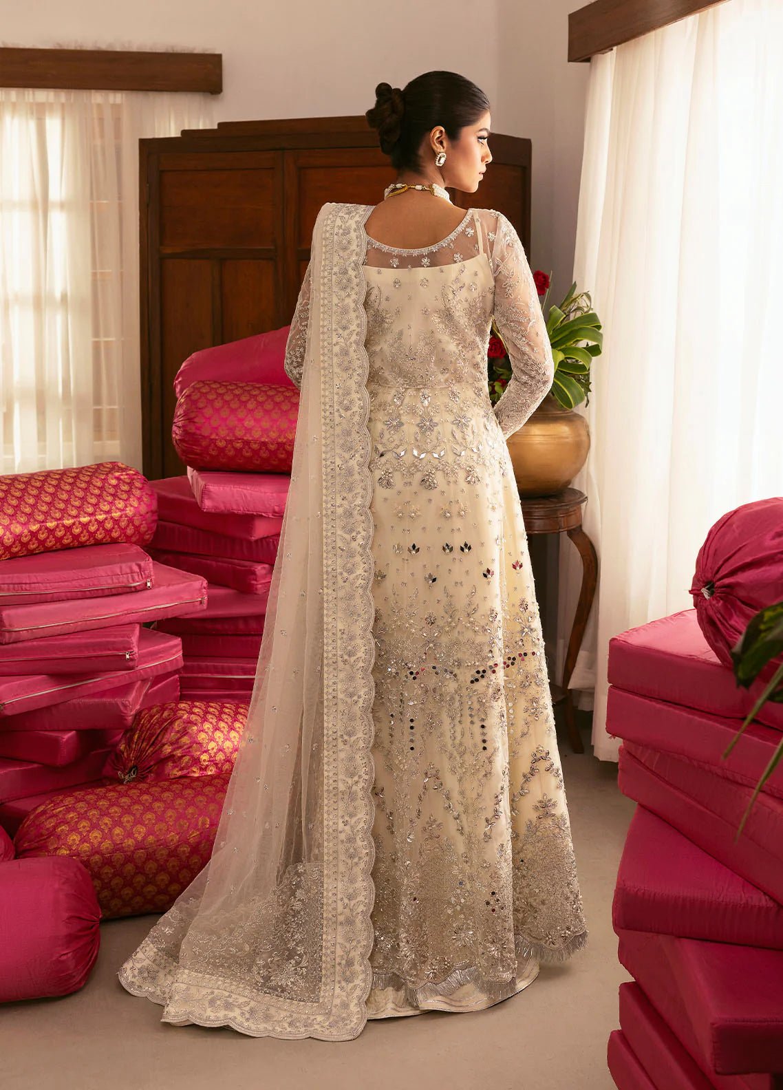 Model wearing Gulaal Sitara ivory silver embroidered chiffon dress with intricate embellishments and matching dupatta. Shop Pakistani clothes online in the UK now.