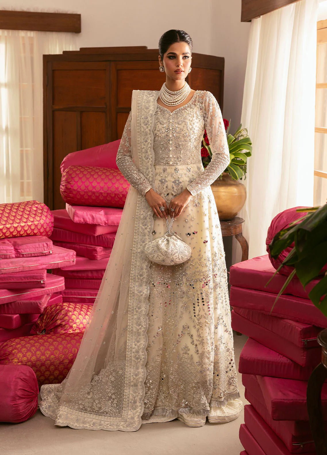 Model wearing Gulaal Sitara ivory silver embroidered chiffon dress with intricate embellishments and matching dupatta. Shop Pakistani clothes online in the UK now.