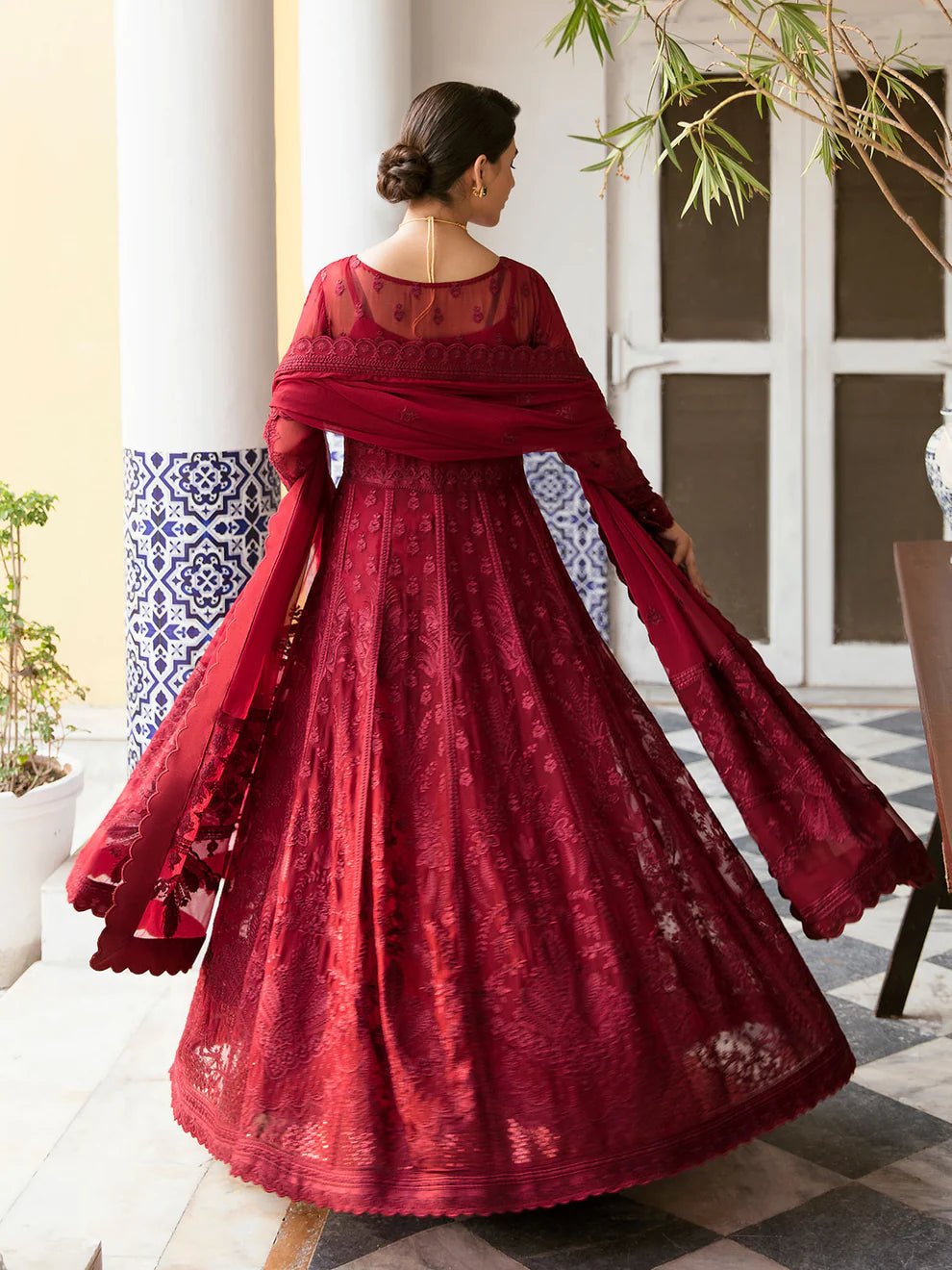 Model wearing a rich red Garnet dress from Gulaal's Embroidered Pret '23 V1 collection, showcasing Pakistani clothes online in the UK.