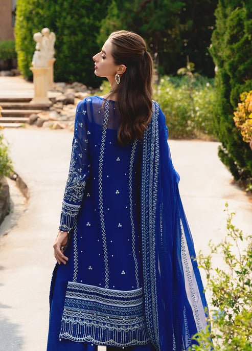 Model wearing Gulaal CELISE dress, royal blue Pakistani attire UK.