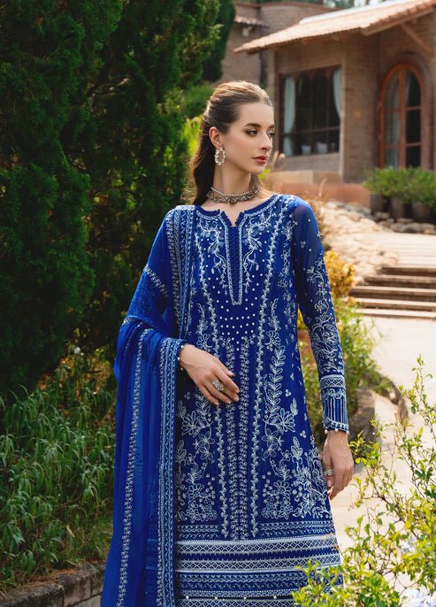 Model wearing Gulaal CELISE dress, royal blue Pakistani attire UK.