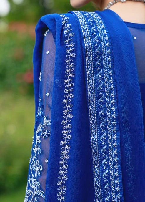 Model wearing Gulaal CELISE dress, royal blue Pakistani attire UK.