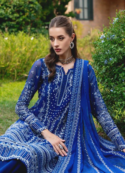 Model wearing Gulaal CELISE dress, royal blue Pakistani attire UK.