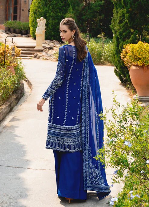 Model wearing Gulaal CELISE dress, royal blue Pakistani attire UK.