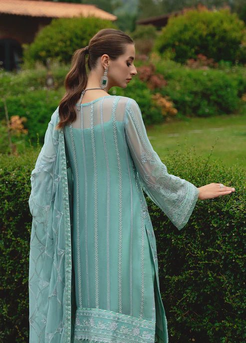 Model wearing Gulaal NISSA dress, sea green Pakistani fashion UK.