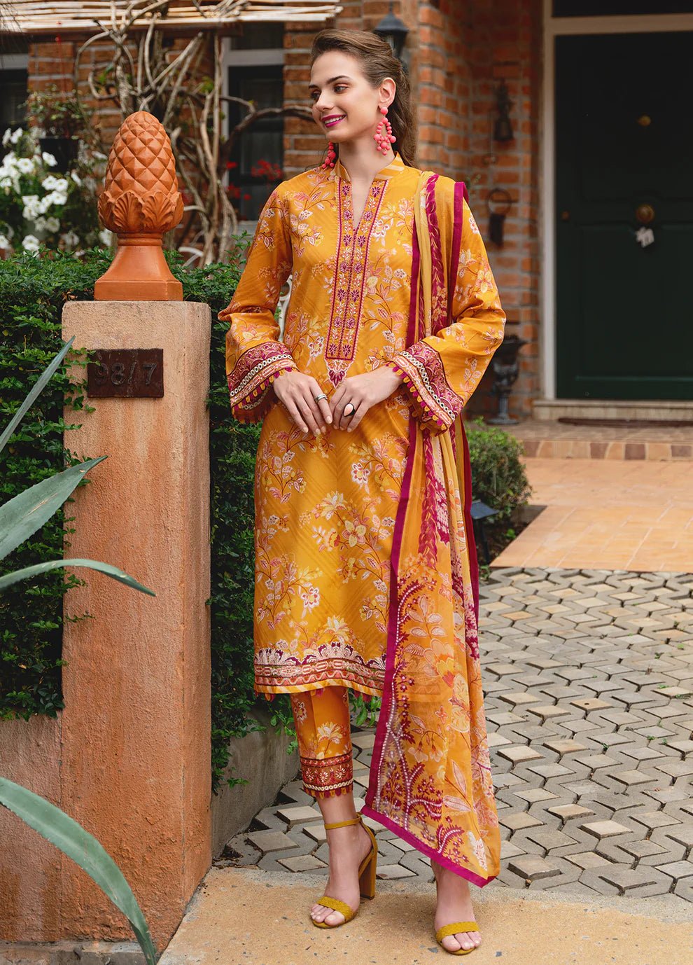 Model in Gulaal FLORENCE, vibrant Pakistani outfit, a UK fashion highlight.