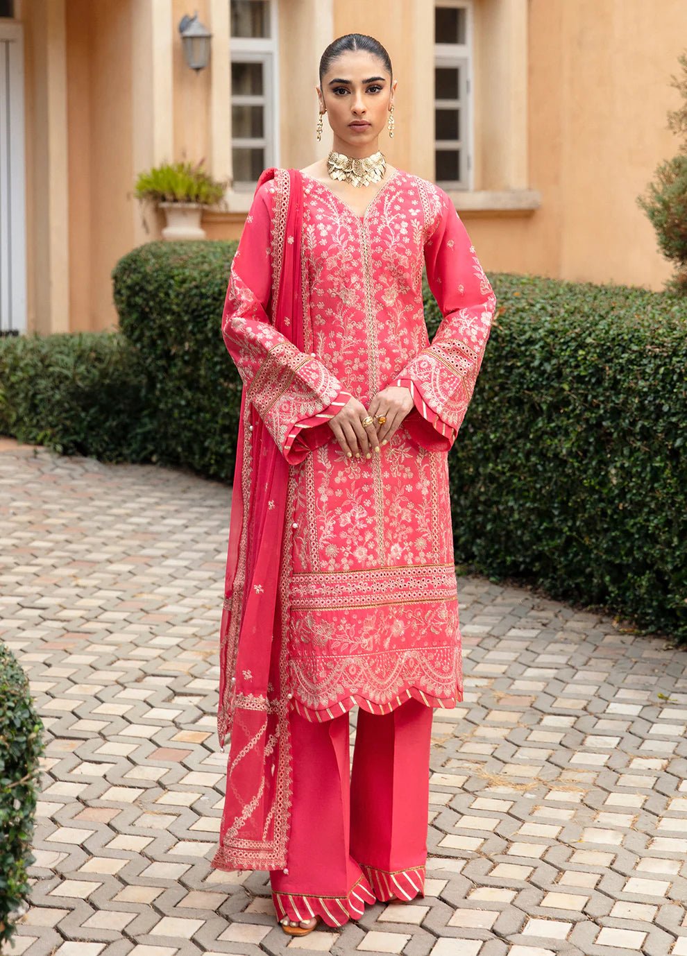 Model in Gulaal's ALESSIA dress, pink luxury lawn with exquisite detailing, a UK Pakistani fashion staple.