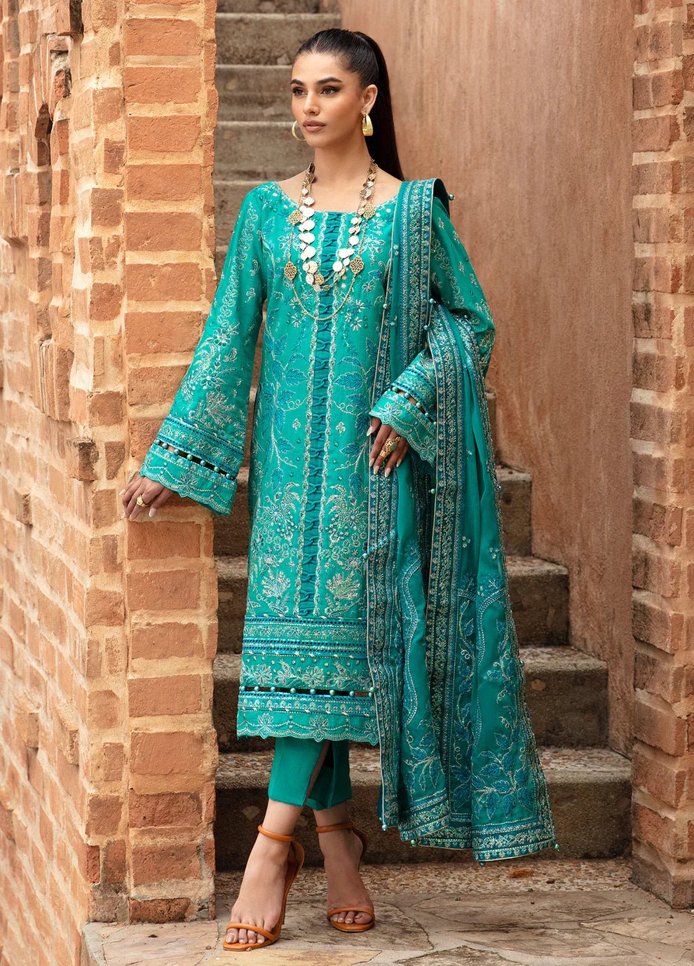 Elegant model in Gulaal's CIANA outfit, teal Pakistani attire, perfect for UK's ethnic wardrobe.