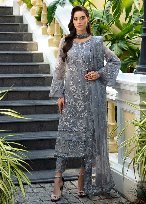 Model wearing the AVIANA silver dress from Gulaal, showcasing luxurious Pakistani clothes online in the UK.