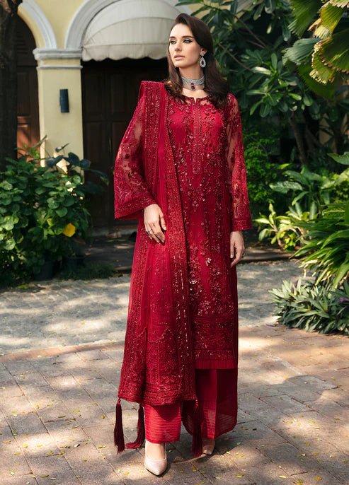 Model wearing Gulaal CHARLOTTE red embellished dress, UK Pakistani luxury attire.