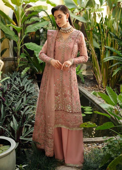 Model wearing Gulaal Luxury Pret pink EVOLETTE dress, elegant Pakistani clothes UK.