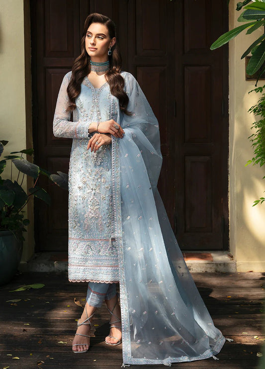 Model in Gulaal's sky - blue MARIAN dress presents elegant Pakistani attire in the UK.