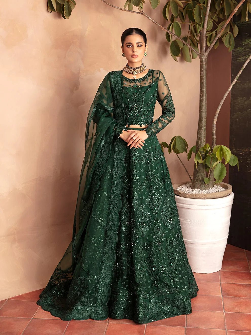 Model wearing a dark green AURORA GL - LP - V2 - 18 dress from Gulaal. Ideal for showcasing Pakistani clothes online in the UK. The dress features intricate embellishments, perfect for luxury pret collections.