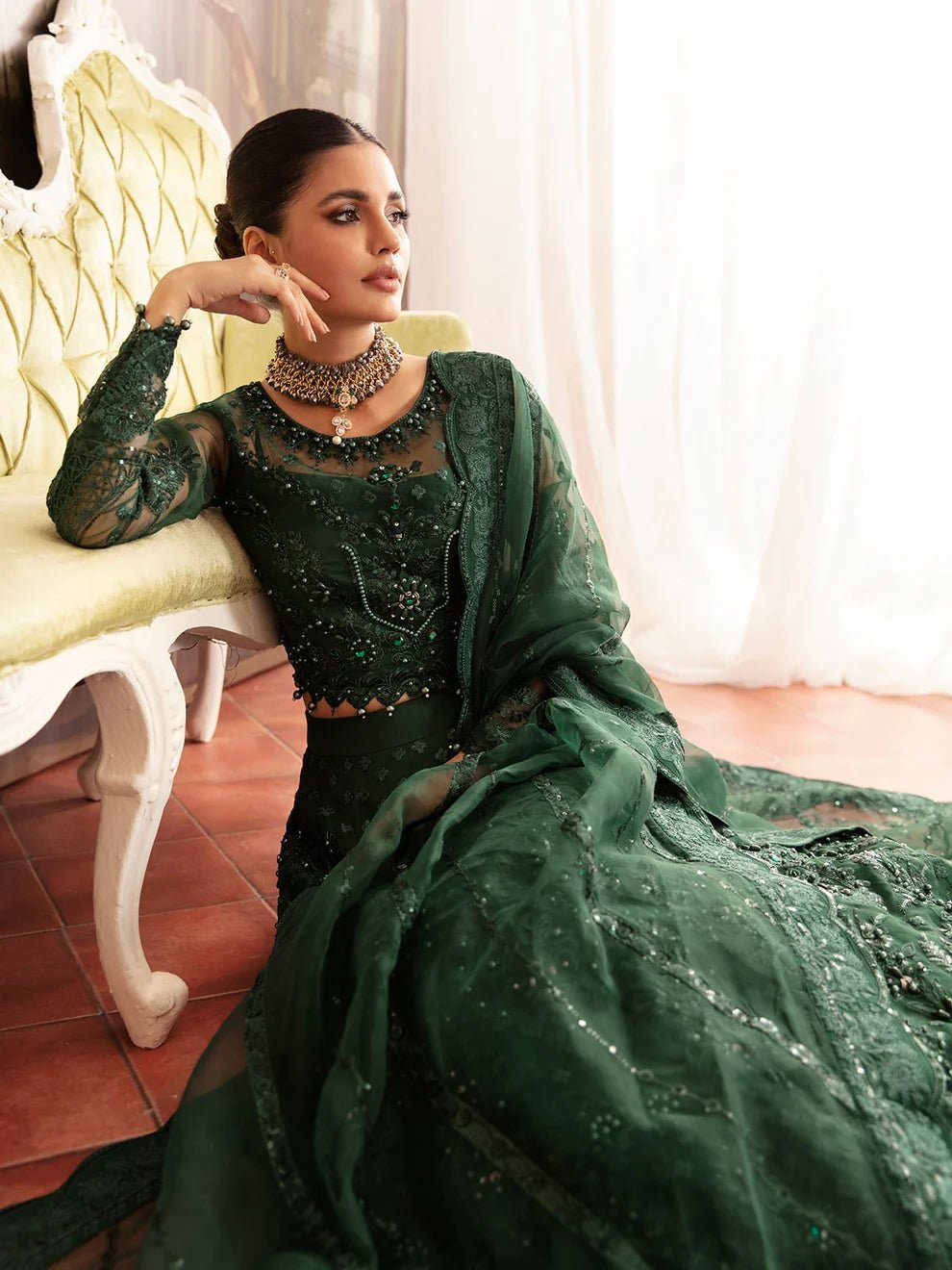 Model wearing a dark green AURORA GL - LP - V2 - 18 dress from Gulaal. Ideal for showcasing Pakistani clothes online in the UK. The dress features intricate embellishments, perfect for luxury pret collections.