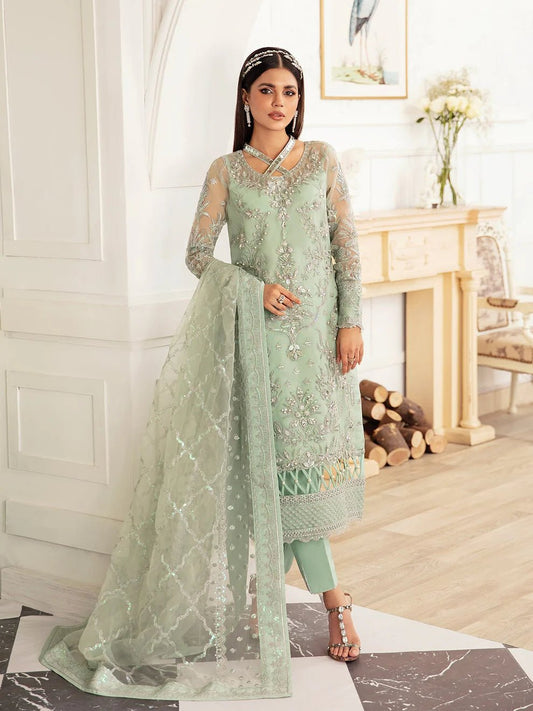 Model wearing a mint green embroidered dress, featuring intricate silver detailing and sheer sleeves from Gulaal. Ideal for showcasing Gulaal's luxury pret collection and Pakistani clothes online in the UK.