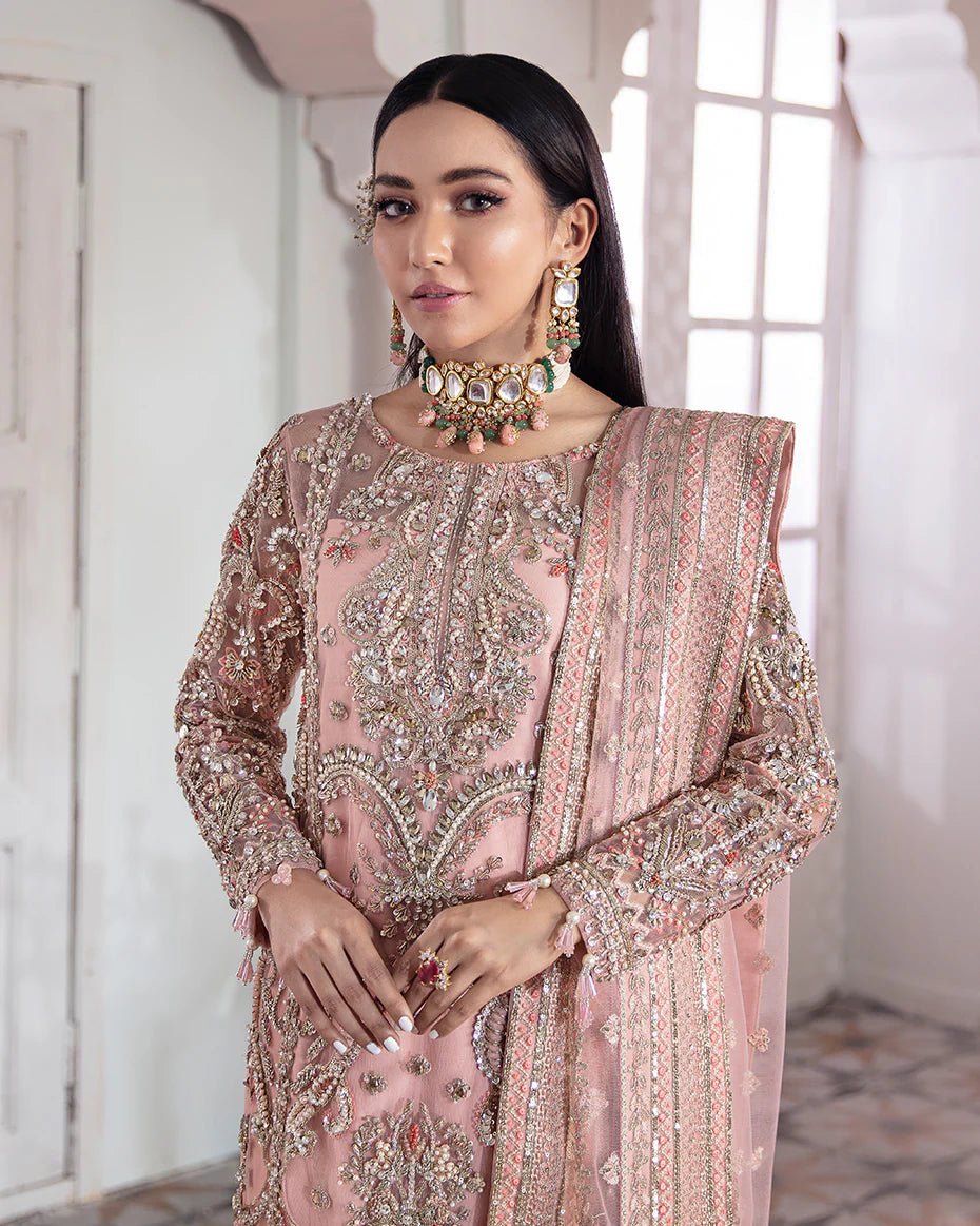 Model wearing a pink Arjumand Embroidered Net 3 - Piece Suit WS - 15 dress from Gulaal's Meherma Wedding Formals, showcasing Pakistani clothes online in the UK.