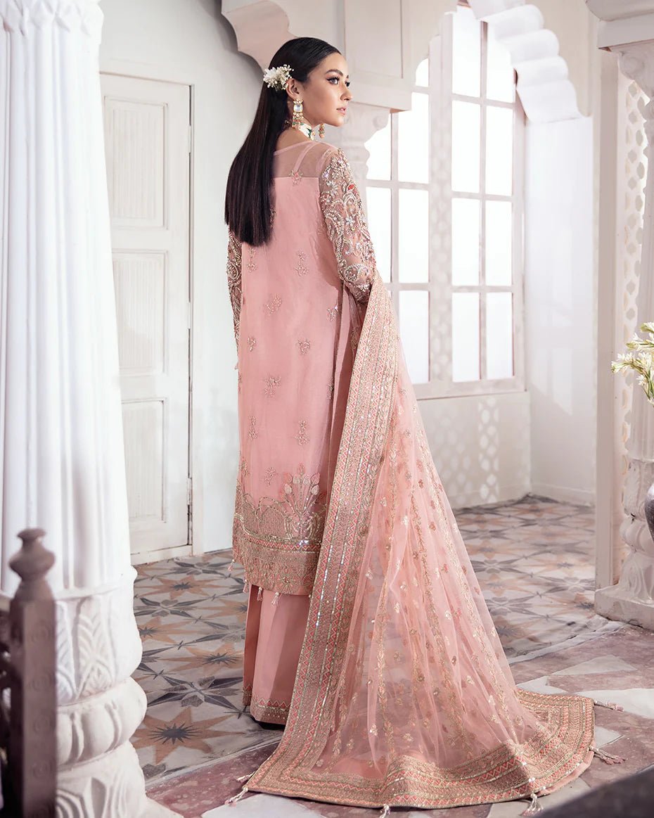 Model wearing a pink Arjumand Embroidered Net 3 - Piece Suit WS - 15 dress from Gulaal's Meherma Wedding Formals, showcasing Pakistani clothes online in the UK.