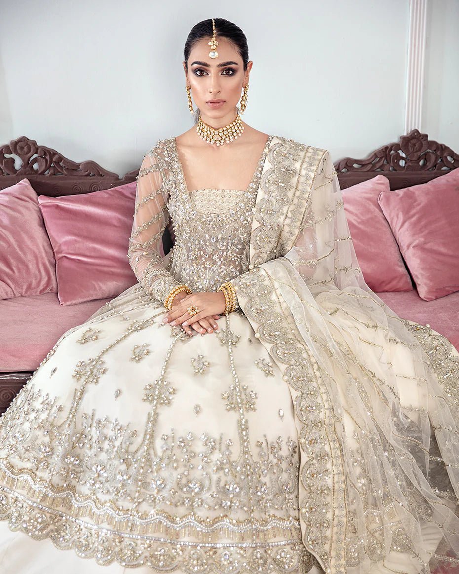 Model wearing an ivory Meeral Embroidered Net 3 - Piece Suit WS - 22 dress from Gulaal's Meherma Wedding Formals, showcasing Pakistani clothes online in the UK.