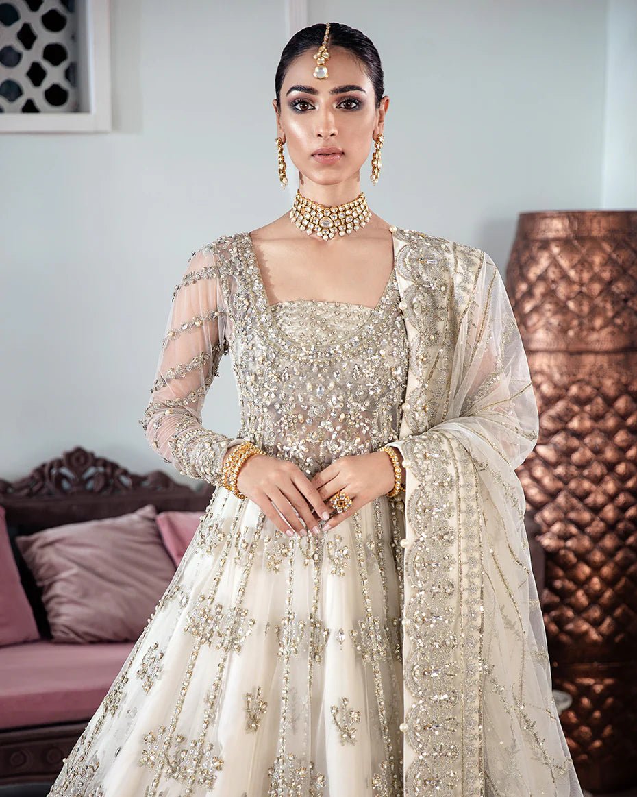 Model wearing an ivory Meeral Embroidered Net 3 - Piece Suit WS - 22 dress from Gulaal's Meherma Wedding Formals, showcasing Pakistani clothes online in the UK.