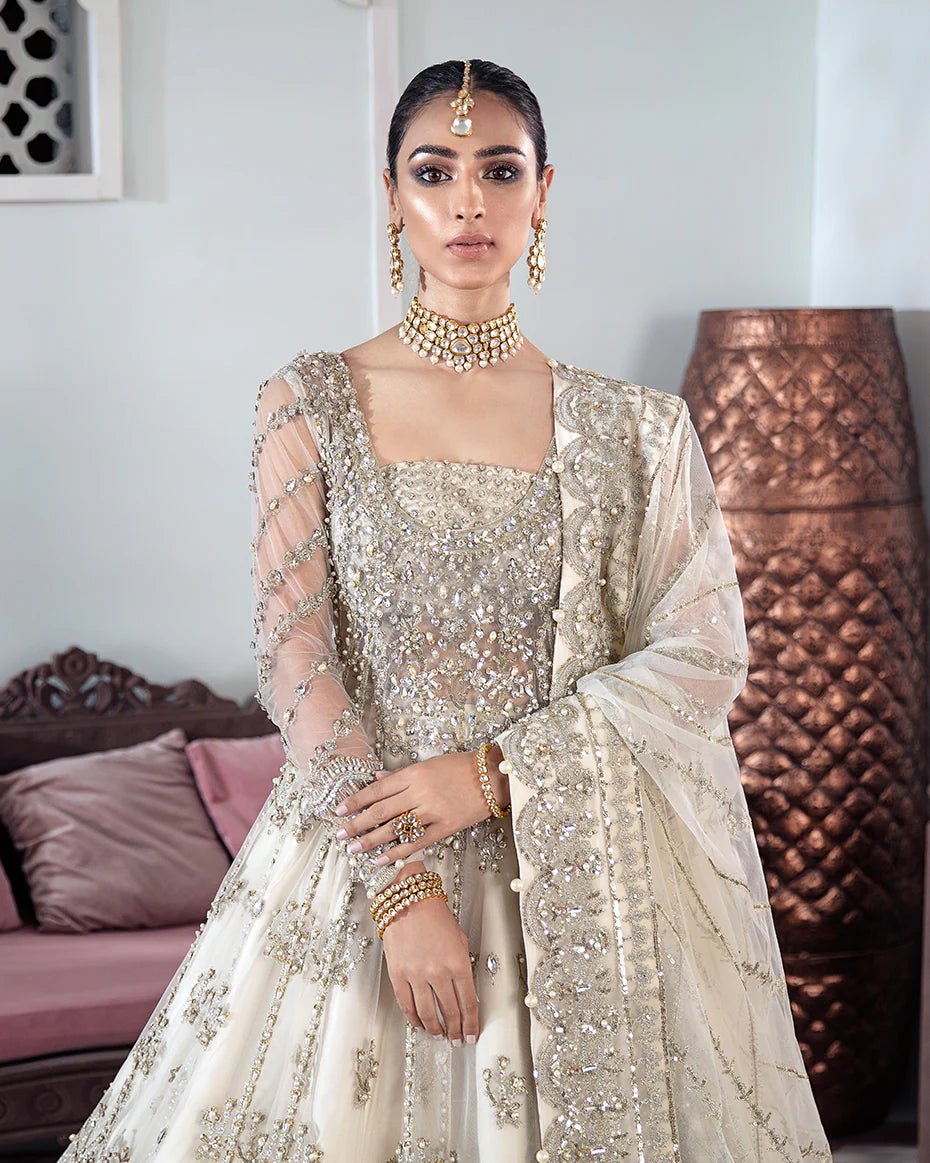 Model wearing an ivory Meeral Embroidered Net 3 - Piece Suit WS - 22 dress from Gulaal's Meherma Wedding Formals, showcasing Pakistani clothes online in the UK.