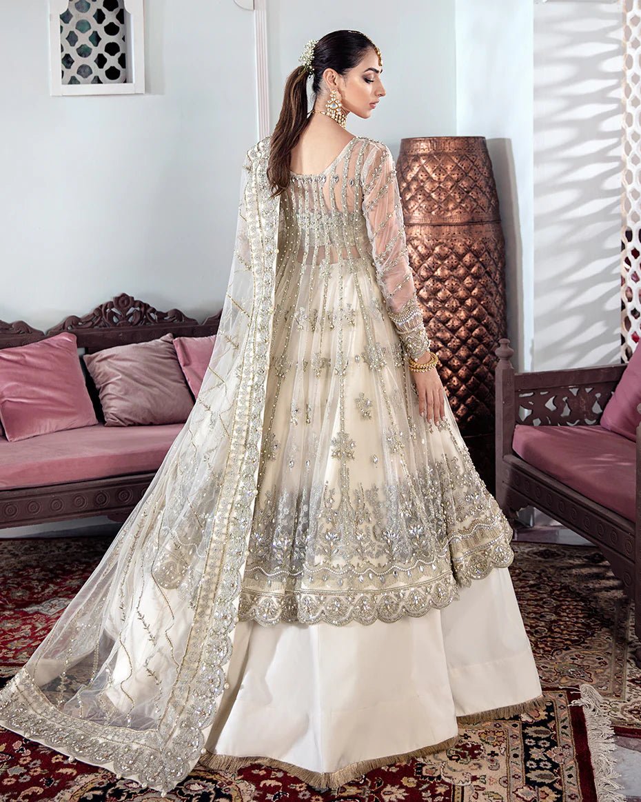 Model wearing an ivory Meeral Embroidered Net 3 - Piece Suit WS - 22 dress from Gulaal's Meherma Wedding Formals, showcasing Pakistani clothes online in the UK.