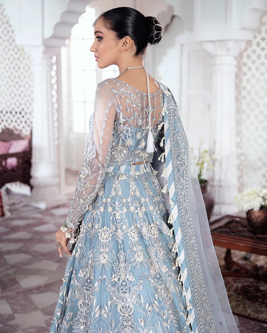 Model wearing a blue Mehnaaz Embroidered Net 3 - Piece Suit WS - 13 dress from Gulaal's Meherma Wedding Formals, showcasing Pakistani clothes online in the UK.