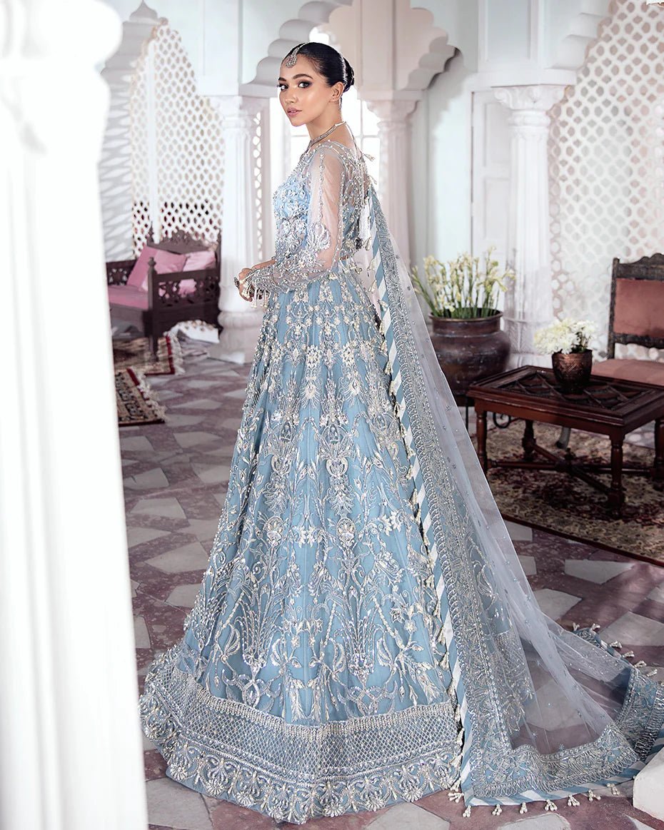 Model wearing a blue Mehnaaz Embroidered Net 3 - Piece Suit WS - 13 dress from Gulaal's Meherma Wedding Formals, showcasing Pakistani clothes online in the UK.