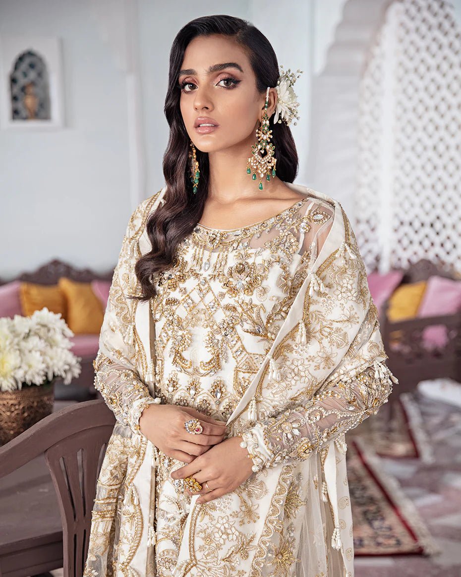 Model wearing an ivory Shehnaz Embroidered Net 3 - Piece Suit WS - 11 dress from Gulaal's Meherma Wedding Formals, showcasing Pakistani clothes online in the UK.