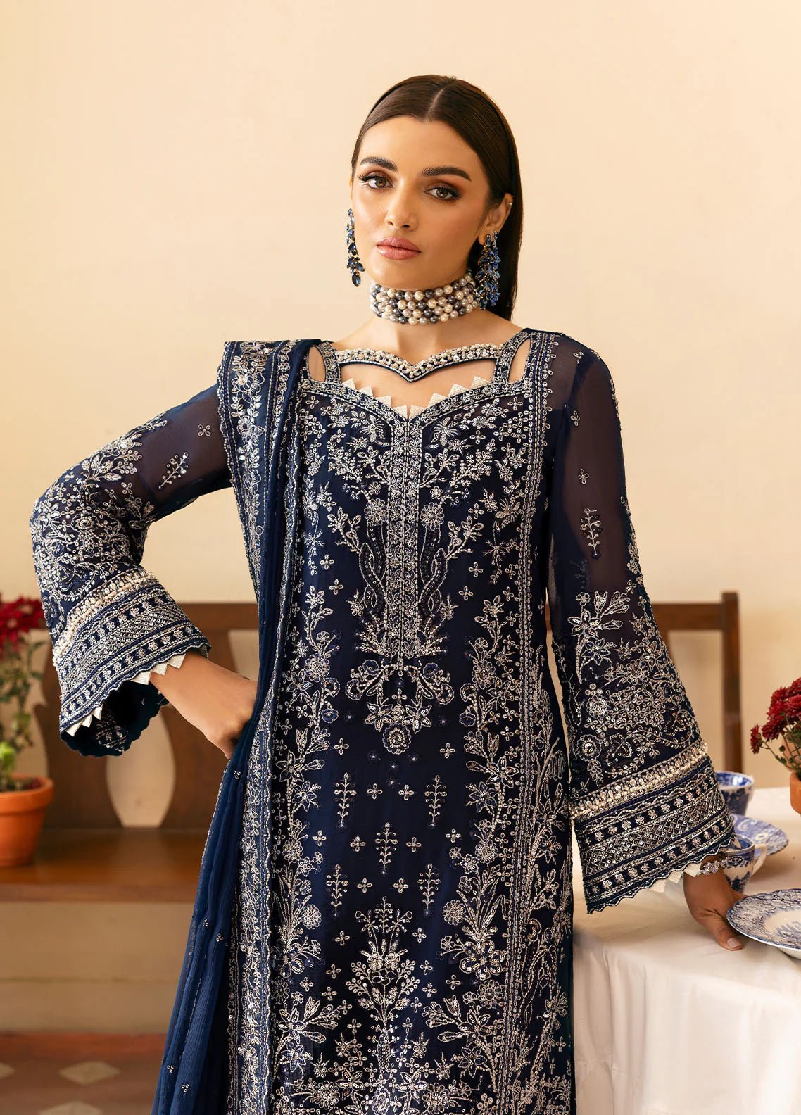 Model wearing Gulaal Arista midnight blue embroidered chiffon dress with intricate silver detailing and matching dupatta. Shop Pakistani clothes online in the UK now.