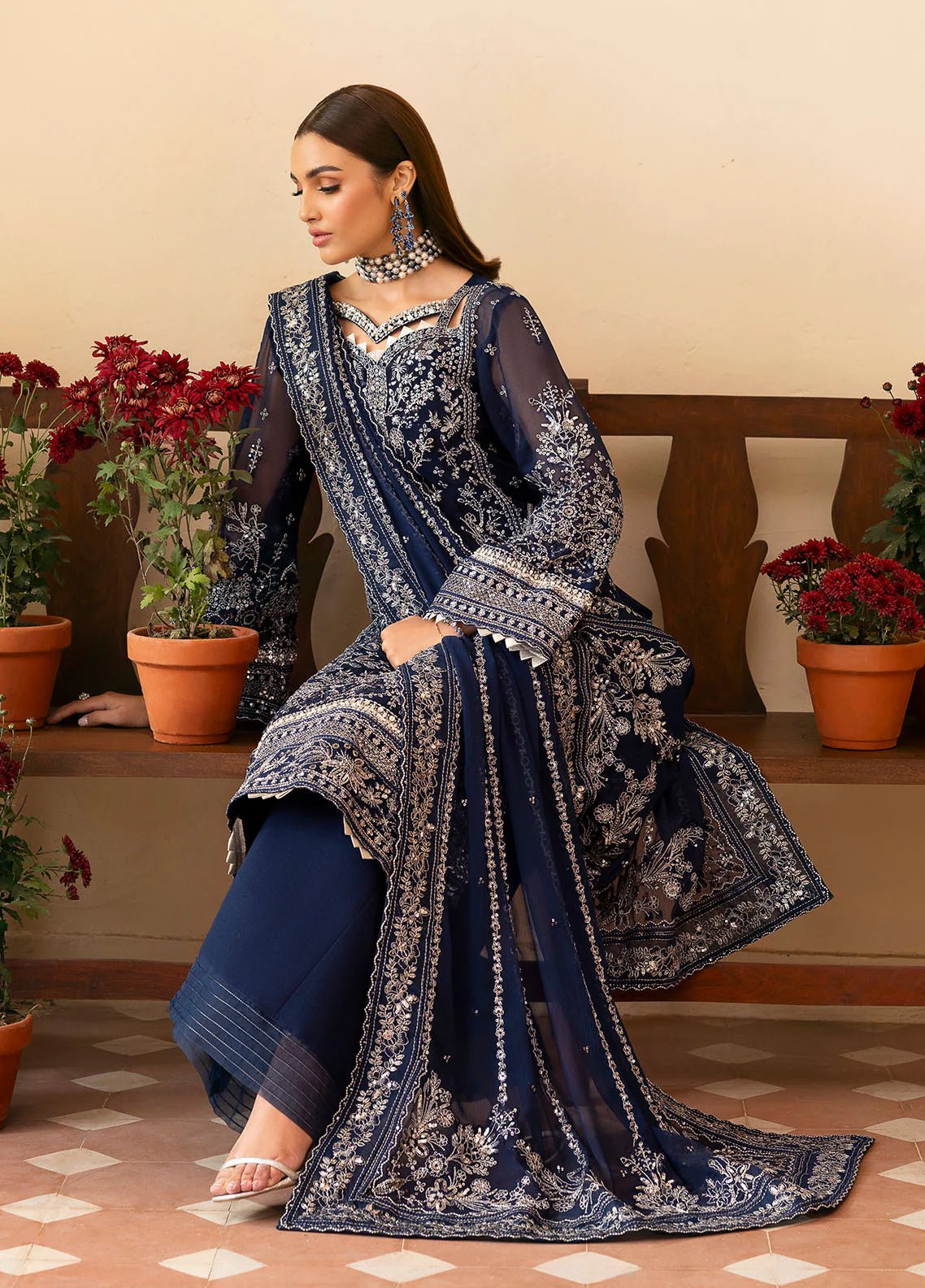 Model wearing Gulaal Arista midnight blue embroidered chiffon dress with intricate silver detailing and matching dupatta. Shop Pakistani clothes online in the UK now.