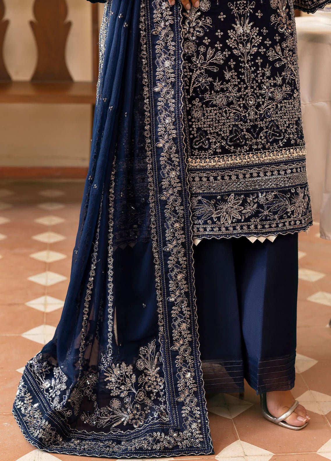 Model wearing Gulaal Arista midnight blue embroidered chiffon dress with intricate silver detailing and matching dupatta. Shop Pakistani clothes online in the UK now.