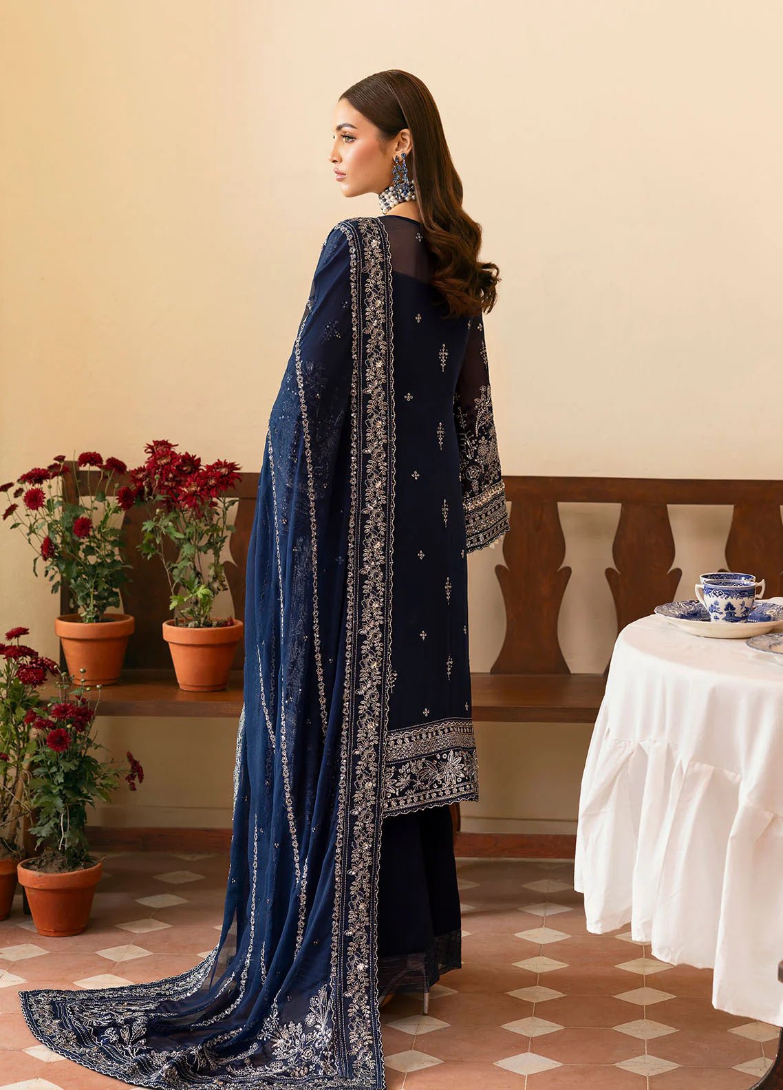 Model wearing Gulaal Arista midnight blue embroidered chiffon dress with intricate silver detailing and matching dupatta. Shop Pakistani clothes online in the UK now.