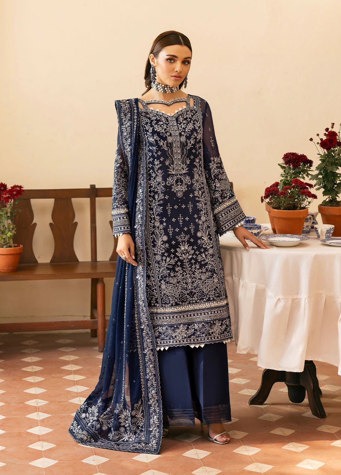 Model wearing Gulaal Arista midnight blue embroidered chiffon dress with intricate silver detailing and matching dupatta. Shop Pakistani clothes online in the UK now.