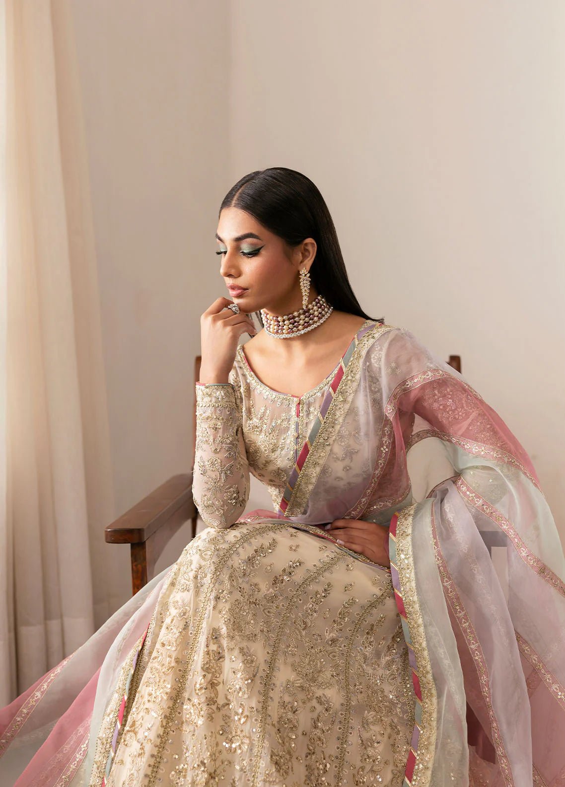 Model wearing Gulaal Chiragh ivory and pink embroidered chiffon dress with embellished dupatta. Shop Pakistani clothes online in the UK now.