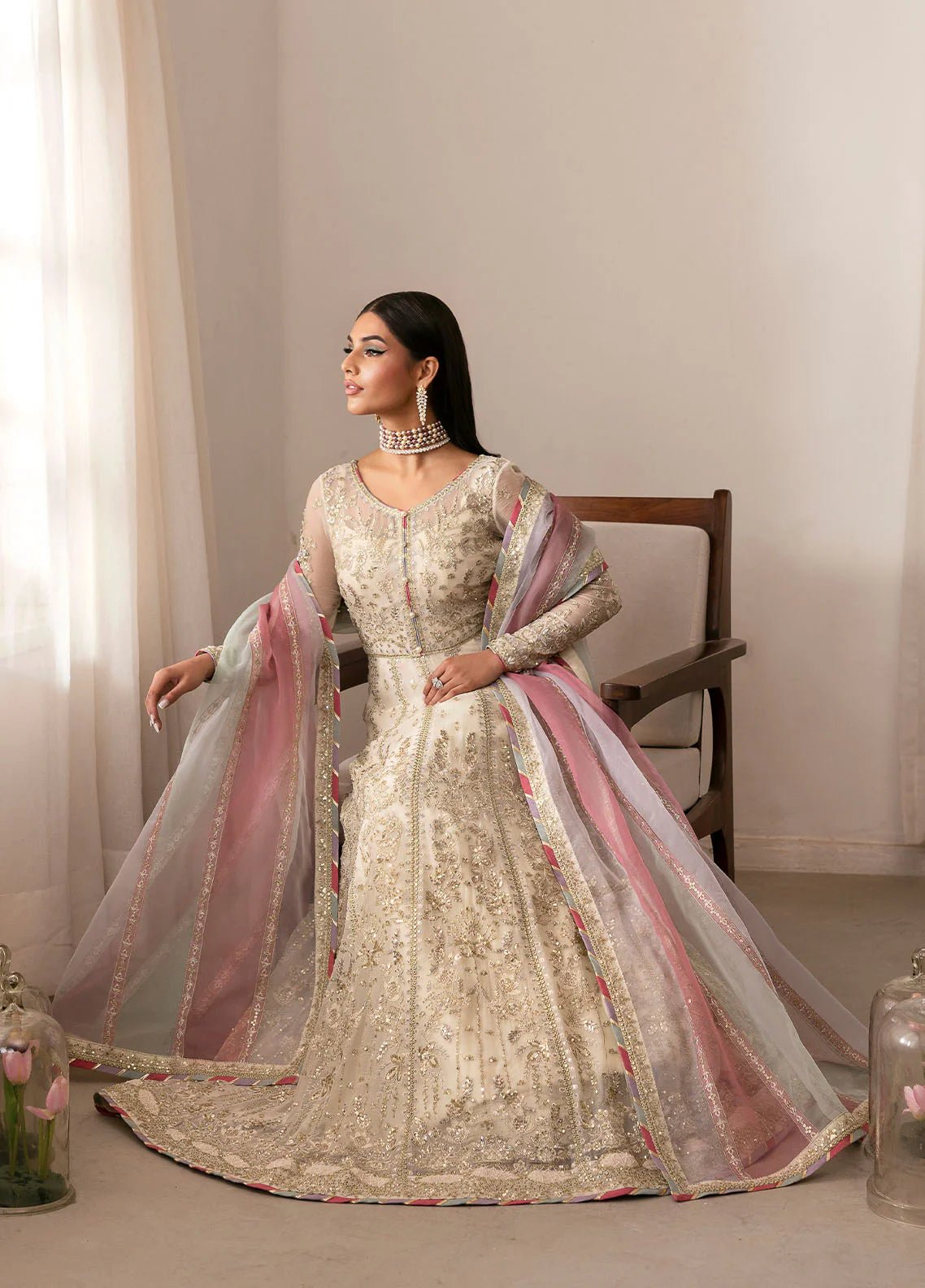 Model wearing Gulaal Chiragh ivory and pink embroidered chiffon dress with embellished dupatta. Shop Pakistani clothes online in the UK now.