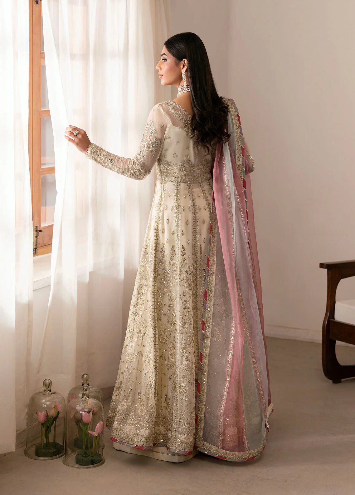 Model wearing Gulaal Chiragh ivory and pink embroidered chiffon dress with embellished dupatta. Shop Pakistani clothes online in the UK now.