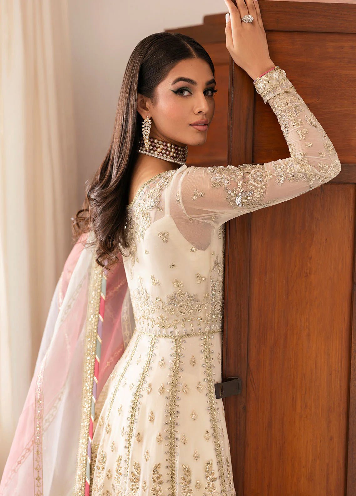 Model wearing Gulaal Chiragh ivory and pink embroidered chiffon dress with embellished dupatta. Shop Pakistani clothes online in the UK now.