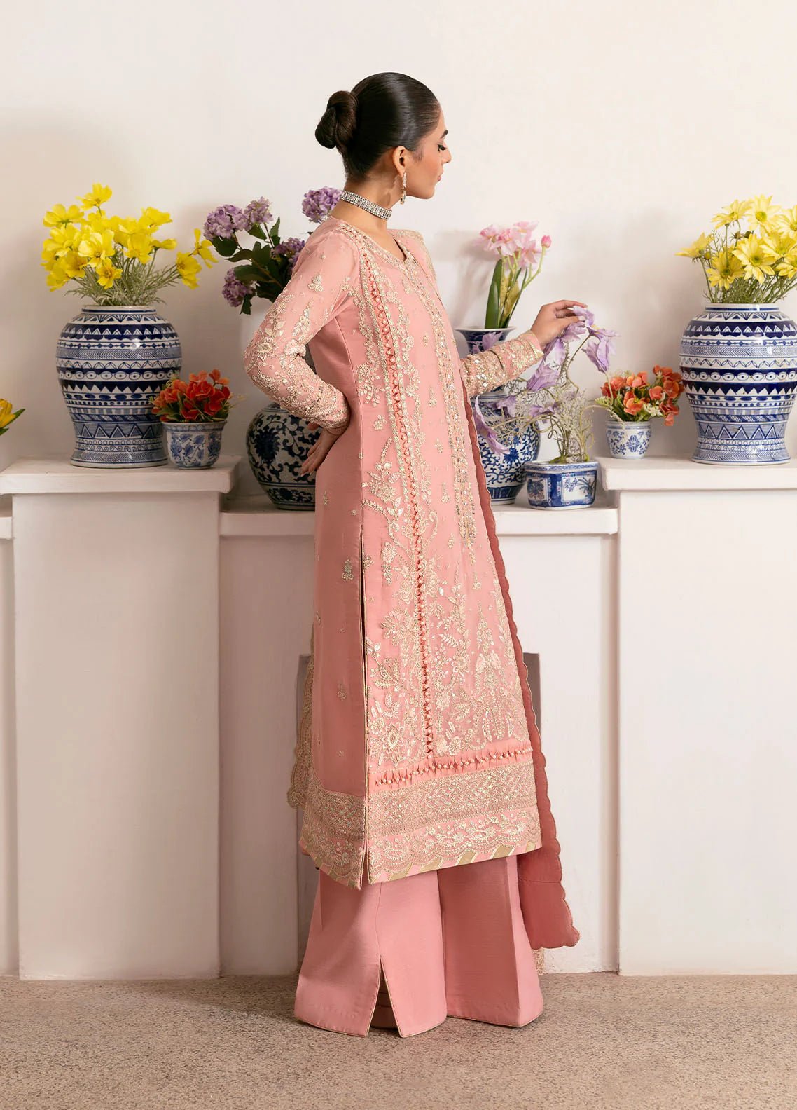 Model wearing Gulaal Coralyn blush pink embroidered chiffon dress with embellished dupatta. Shop Pakistani clothes online in the UK now.